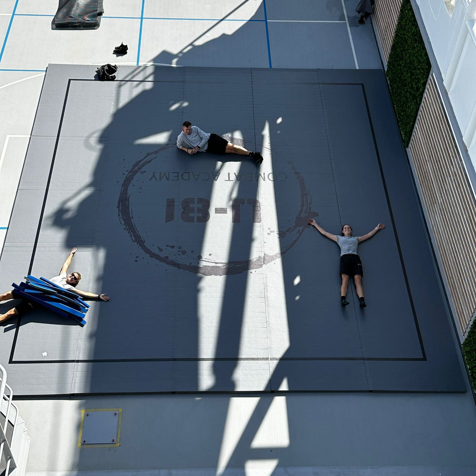 guys laying on a roll out mat